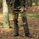 Man wearing German flecktarn camo military style field cargo pants standing in a forest setting