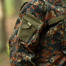 Close-up of MFH Brand U.S. Military style jacket in flecktarn camo ripstop with arm pocket and hook and loop patch panel