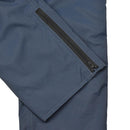 Close-up of blue waterproof RAF rain trousers leg with black zipper detail for wet weather protection.