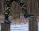 Original Germany army BALTES black and OD green tropical military boots worn outdoors on wooden posts