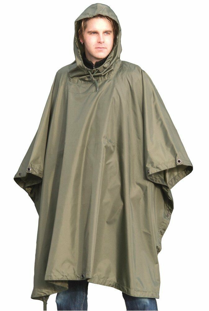 Man wearing olive green waterproof military-style ripstop rain poncho with hood for outdoor protection
