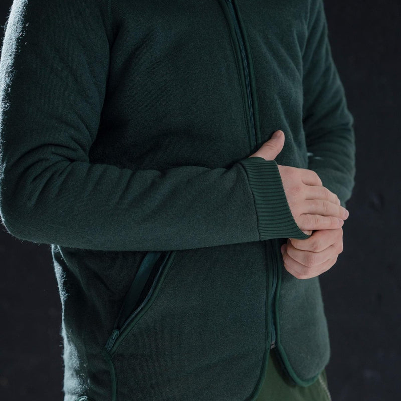 Close-up of green Dutch army thermal fleece parka liner with thumb holes and zippered side pockets for cold weather.
