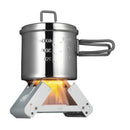 ESBIT small foldable pocket cooking stove with solid fuel, heating a metal pot with measuring marks on a campfire flame