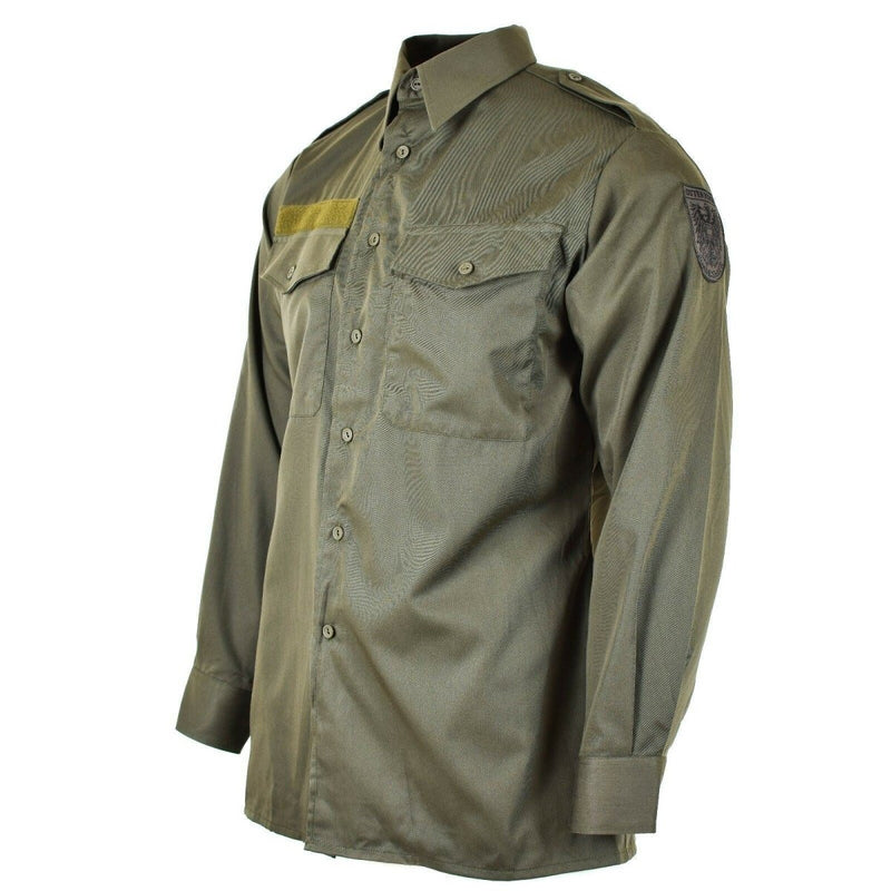 Genuine Austrian army M65 olive green military combat shirt with long sleeves, pockets, and button-up design.