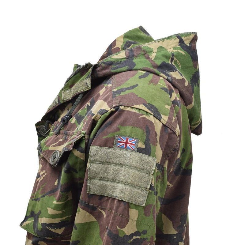 Side view of genuine British Army SAS combat smock with DPM camo, hood, and Union Jack patch on sleeve