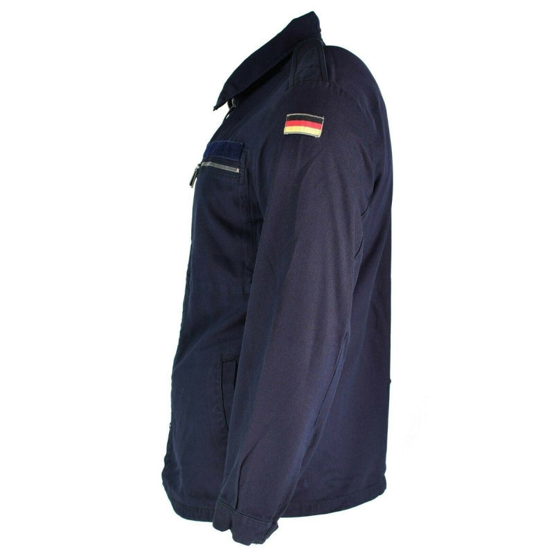 Side view of a blue German Navy fire-resistant aramid jacket with zipped chest pocket and German flag on sleeve