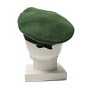 Green wool German police beret hat with metal cockade insignia displayed on a white mannequin head.