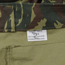 Close-up of genuine Greek military jacket size label with dark lizard camo pattern and durable stitching detail
