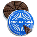 Round blue tin of German Scho-Ka-Kola milk chocolate with caffeine, segmented into wedge-shaped pieces.