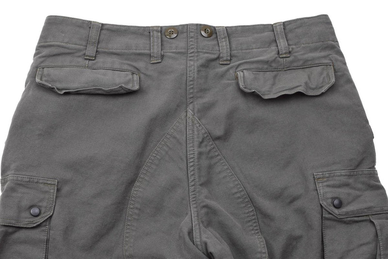 Close-up of olive green Leo Kohler combat military pants with multiple pockets and reinforced stitching.