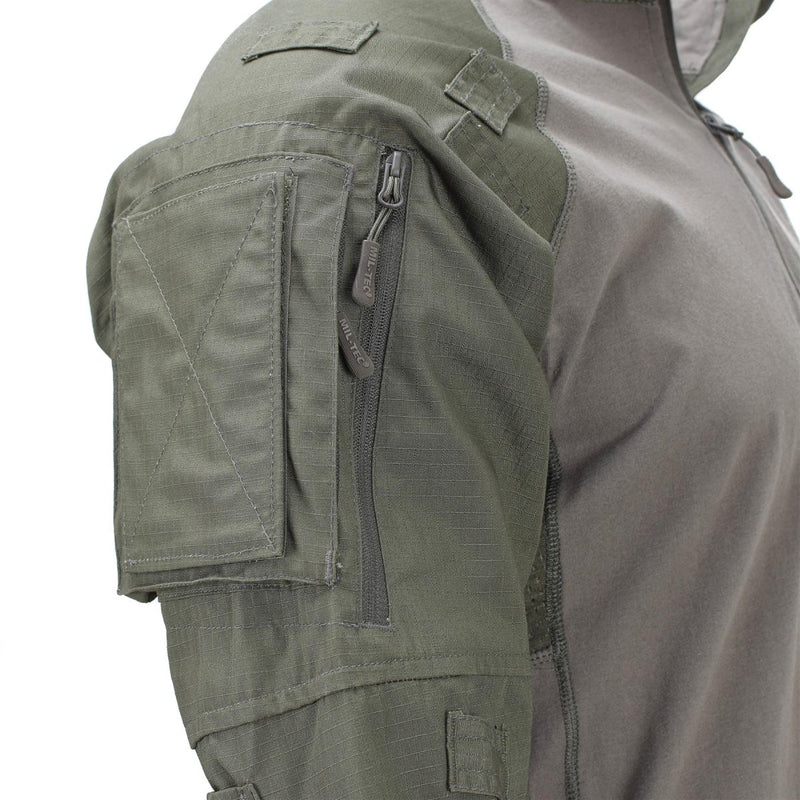 Close-up of olive green MIL-TEC tactical combat shirt sleeve with zippered pocket and reinforced stitching details