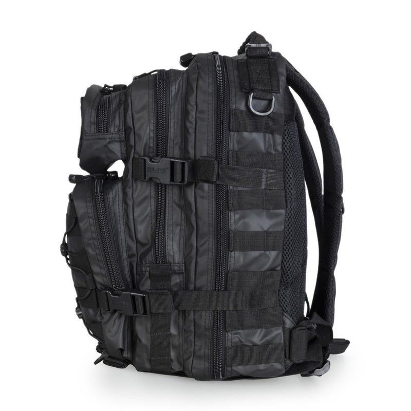 Black MIL-TEC U.S. Assault tactical backpack with multiple compartments and adjustable padded straps for hiking and camping.