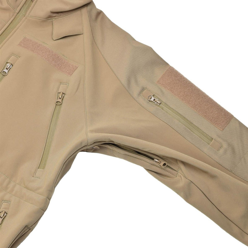 Close-up of coyote colored MIL-TEC windproof hiking soft shell jacket with zippered pockets and fleece liner.
