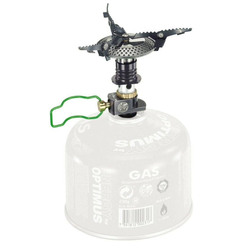 Compact foldable Optimus Crux camping stove attached to small gas canister for lightweight outdoor cooking and hiking trips
