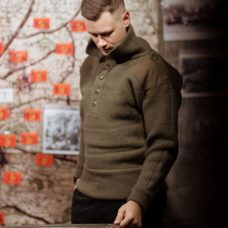 Man wearing an olive green original Austrian Army Alpine wool pullover sweater with high collar and button closure