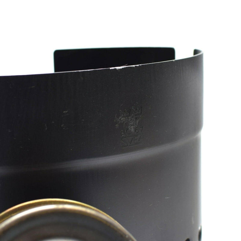 Black metal windshield for Trangia Svea stove with embossed Austrian mess kit logo visible on surface