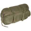 Olive green original British military sleeping bag in compressed sack for cold weather camping and survival use