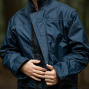 Close-up of a person wearing a blue original British RAF waterproof foul weather parka raincoat outdoors