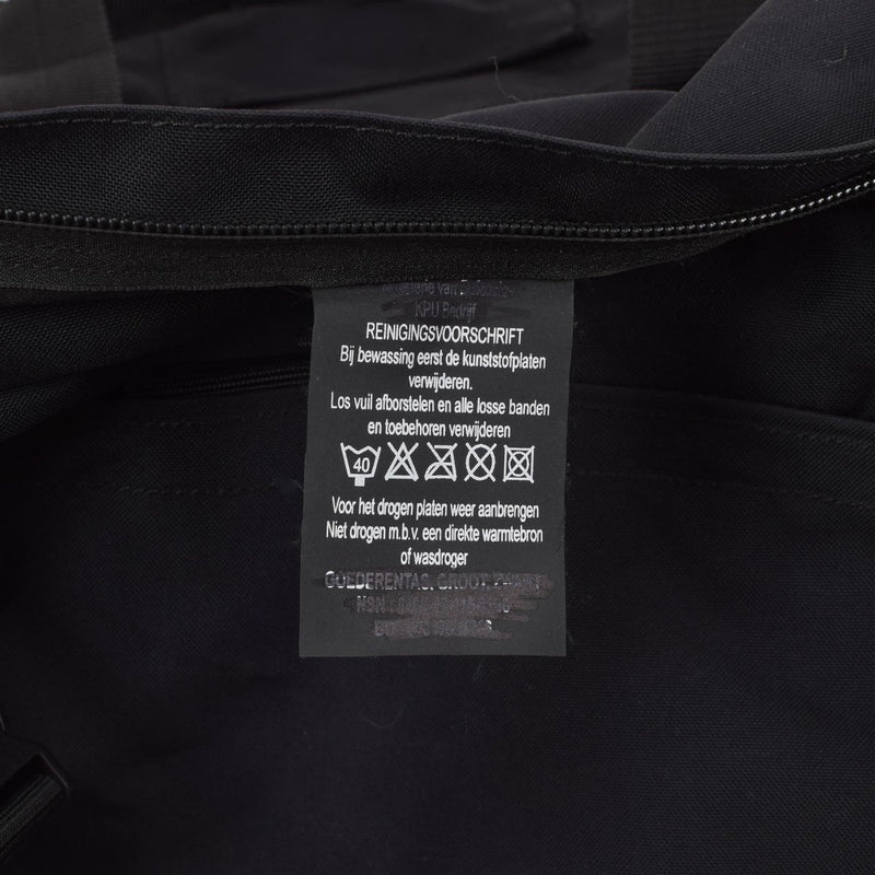 Close-up of black Original Dutch Military duffle bag interior showing care and washing labels.