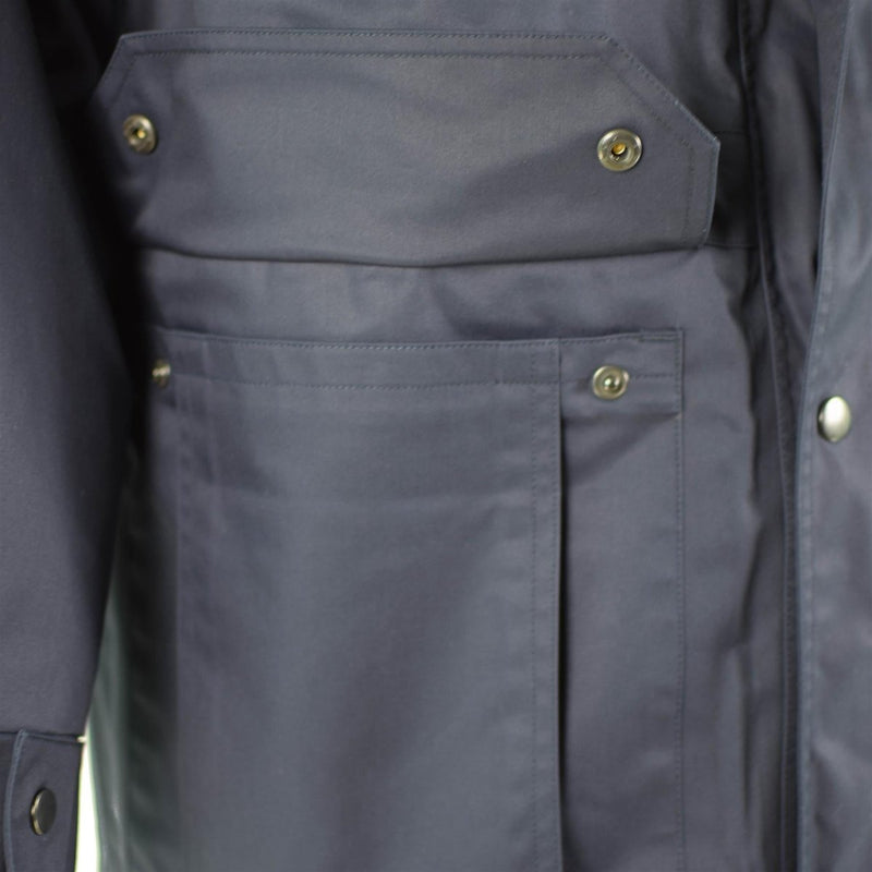 Close-up of dark blue Dutch police issue parka pocket with snap buttons on durable military surplus jacket liner