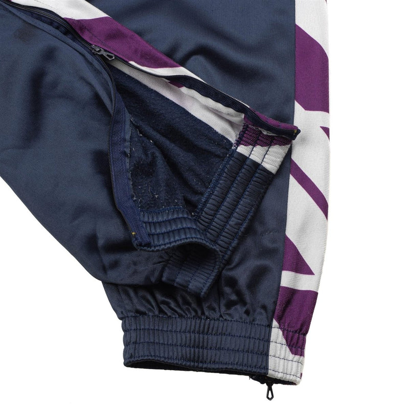 Close-up of navy blue French military school sweatpants with elasticated ankle and side zipper detail.
