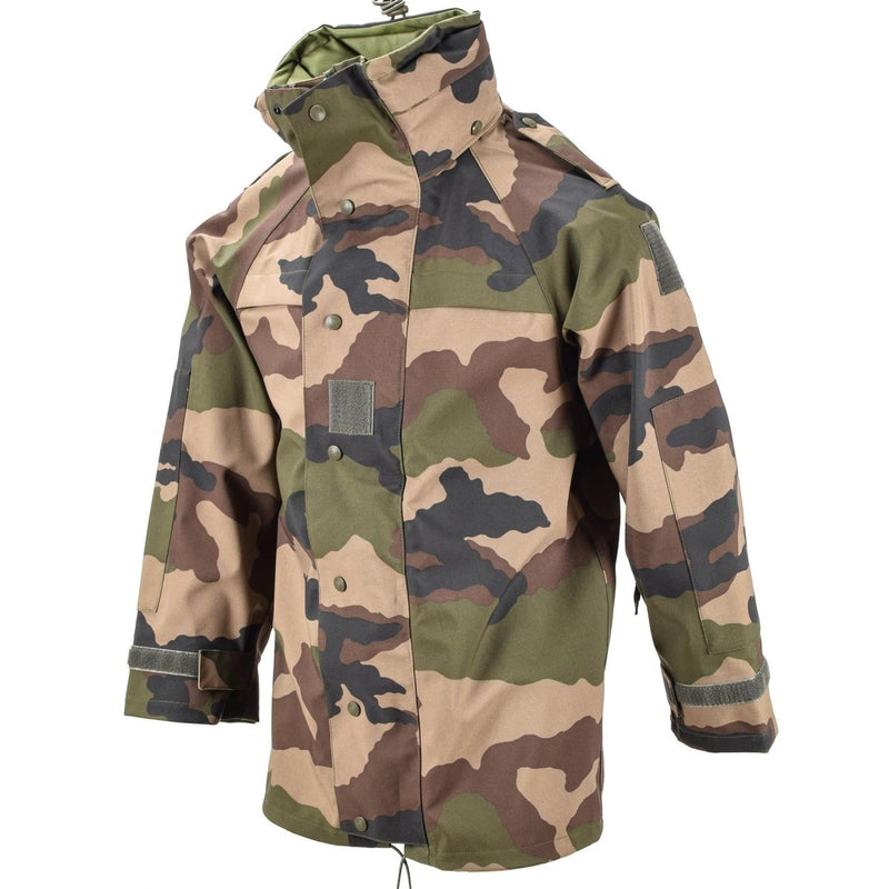 Genuine French Military trilaminate waterproof field jacket with CCE camo, reinforced elbows, and hood for outdoor protection.