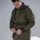 Man wearing a quilted olive green German army field jacket parka with knit collar and cuffs fastening zipper