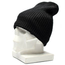 Vintage black German army winter hat knitted beanie with windproof lining displayed on white mannequin head