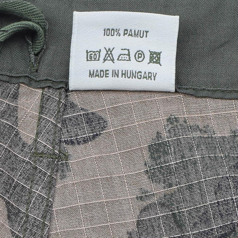 Clothing label on Hungarian military ripstop fabric pants showing care instructions and made in Hungary text.