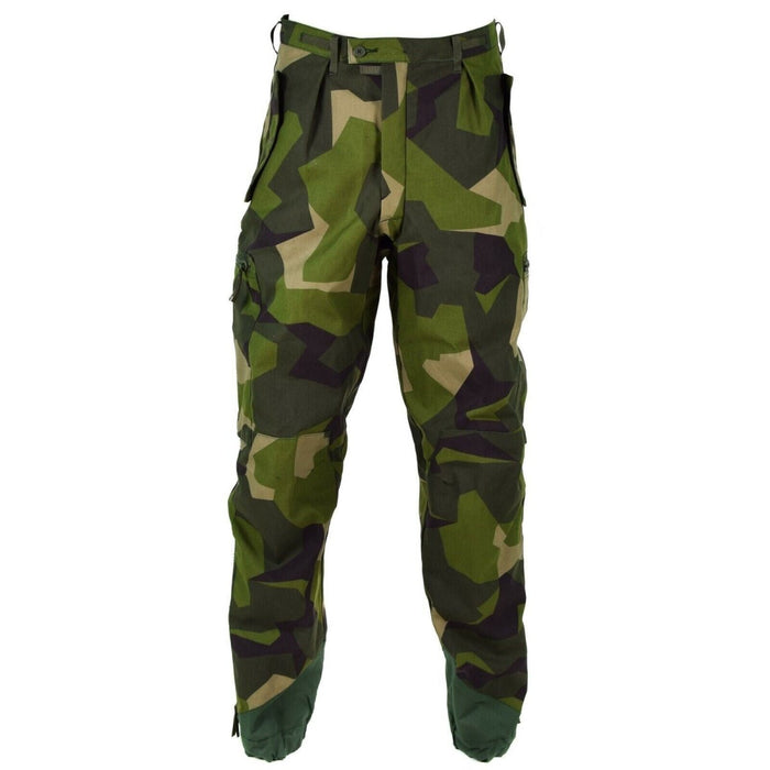 Originele M90-broek van het Zweedse leger in splintercamouflage met versterkte knieën, enkelritsen en veilige zaksluitingen voor duurzaamheid.