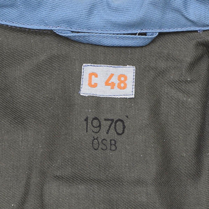 Close-up of 1970 vintage Swedish Civil Defense jacket label with size C48 and blue denim lining visible.