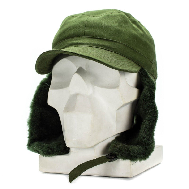 Swedish military M59 winter cap in green with earflaps and faux fur lining for cold weather protection.