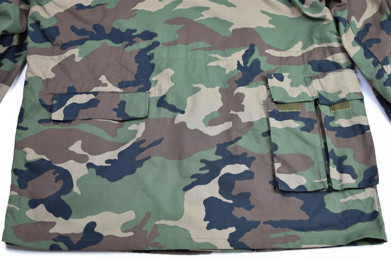 Close-up of original vintage Slovakian army field jacket M97 camo with multiple pockets and adjustable waist detail
