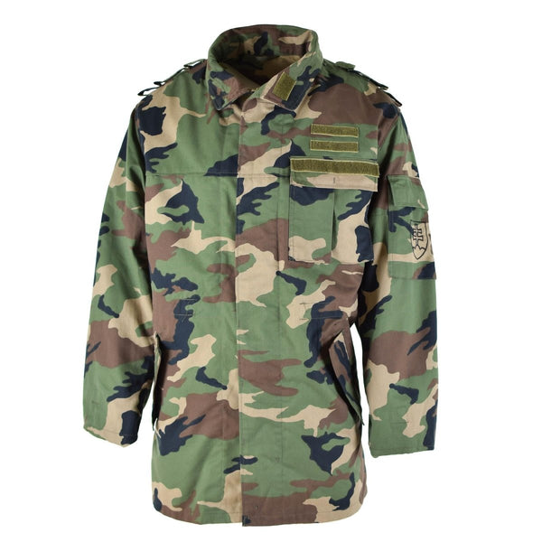 Vintage Slovakian M97 camouflage military field jacket with multiple pockets and adjustable waist and cuffs.