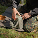 Person unpacking original Yugoslavian army military mess kit canteen and cutlery outdoors on grass