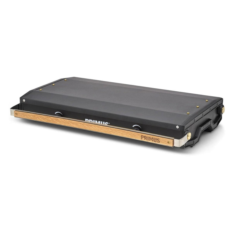 Closed Primus Kinjia dual burner portable camping stove with black body and wood-accented handle for outdoor cooking.