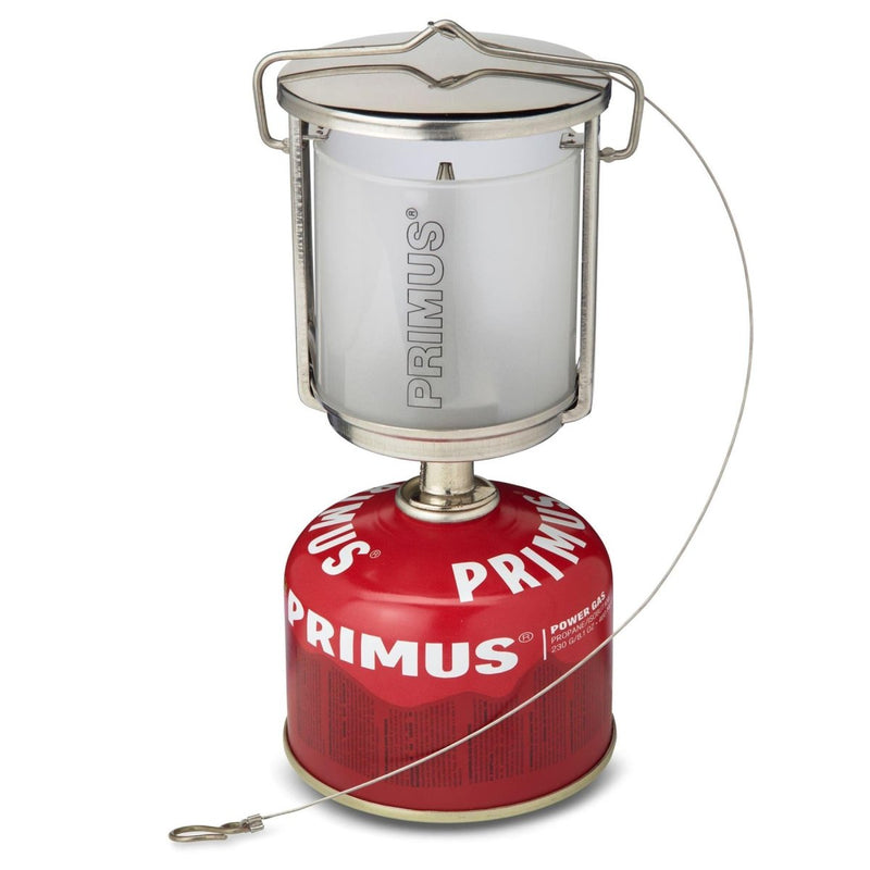Primus Mimer portable camping lantern with stainless steel body and frosted glass on red gas fuel canister.