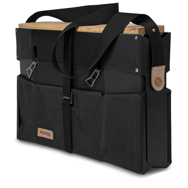 Compact Primus Onja dual burner camping stove folded with carrying strap and storage pockets for outdoor cooking.